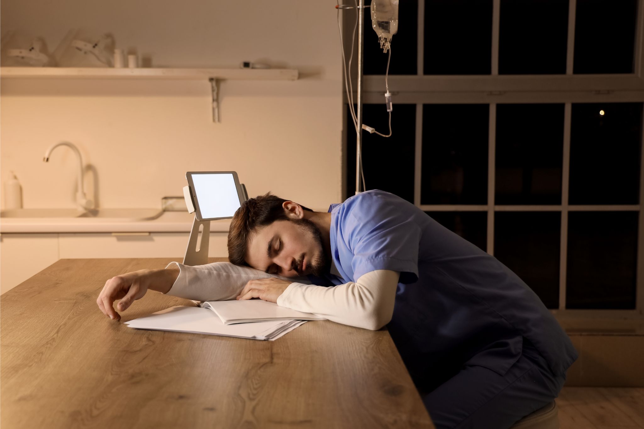 Enfermero durmiendo en una mesa de la clínica